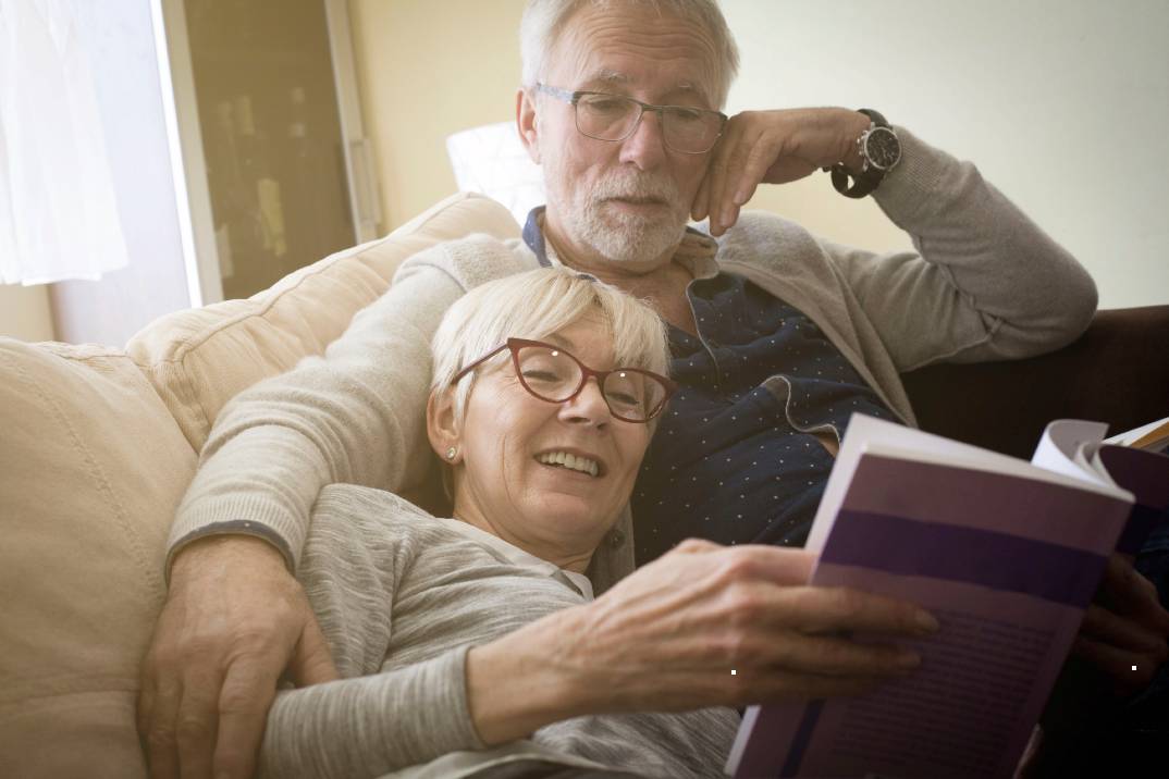 Senior man and woman reading together