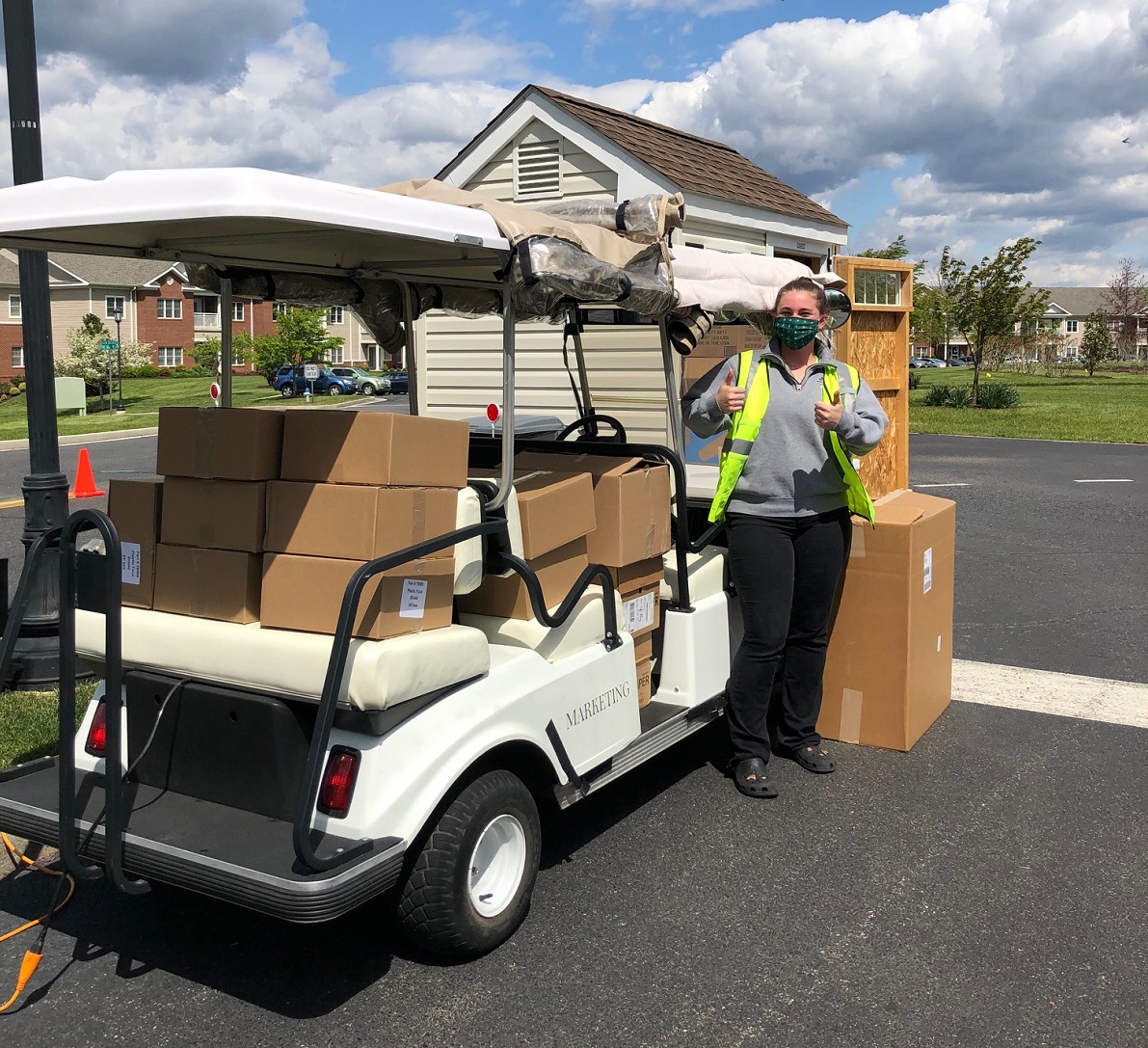 Golf Cart with boxes of supply being deliverd to The Glebe retirement community