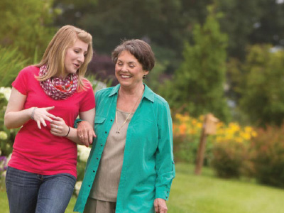 two women walking at an assisted living facility