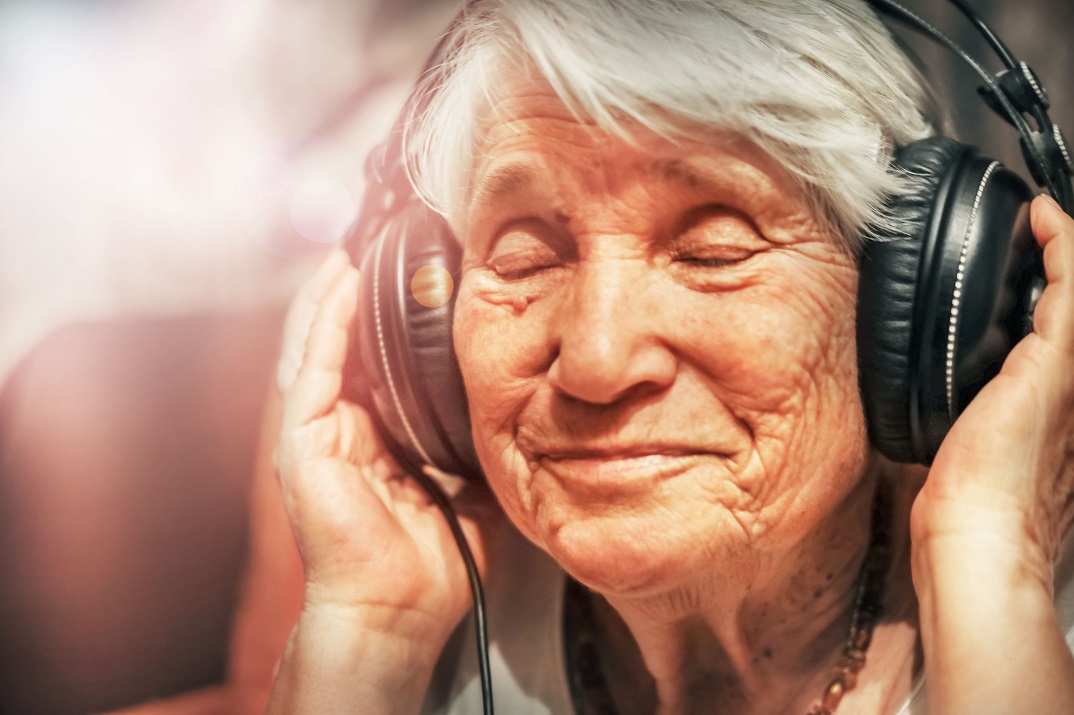 senior woman enjoying music with headphones